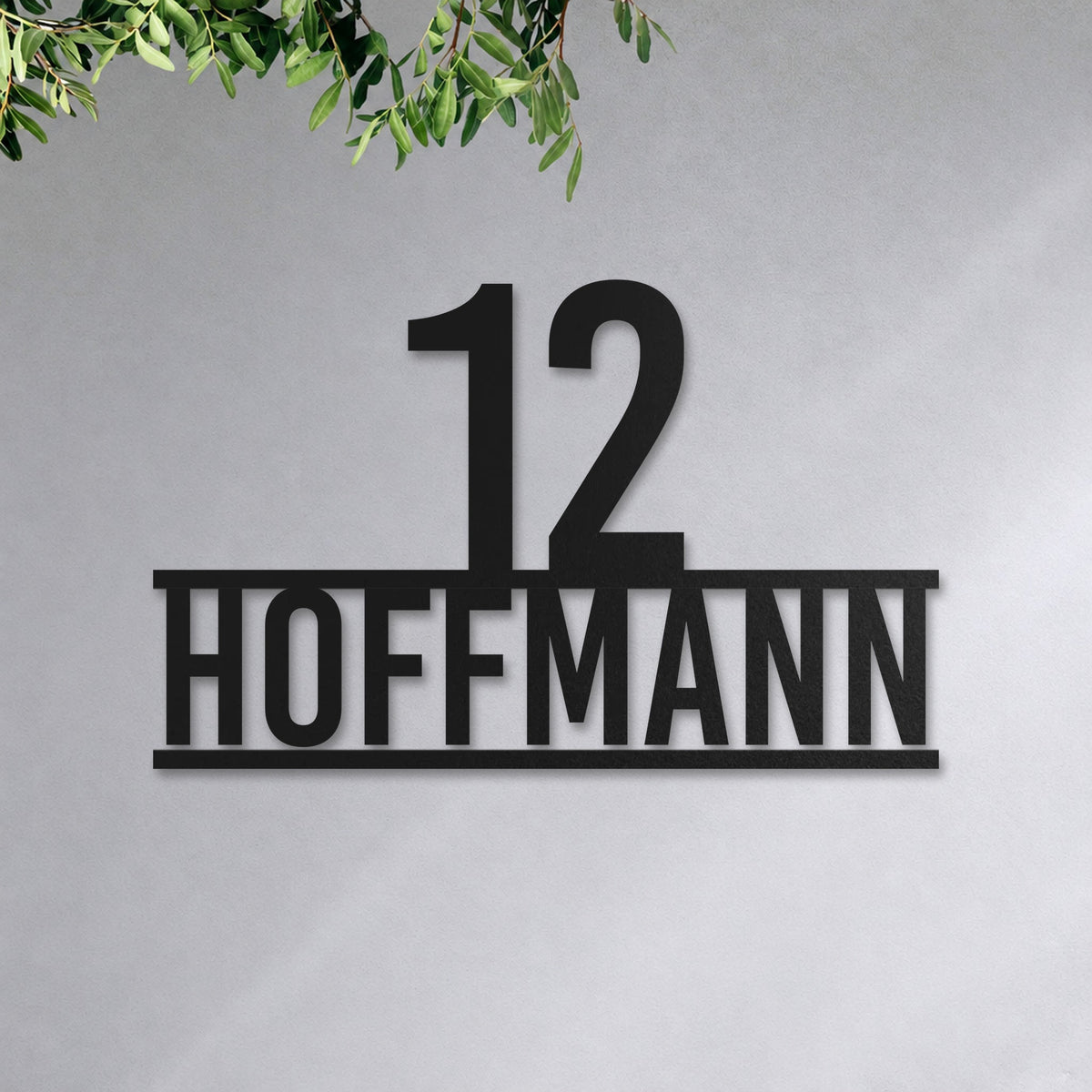 Edelstahl Hausnummernschild personalisiert – Stolze Nummer auf Namen „12 Hoffmann“ an der Hauswand, Edelstahl Schwarz RAL 9005 · WesterWerk